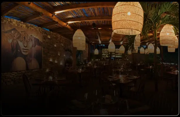 Tulum restaurant with pendant lights and a mural