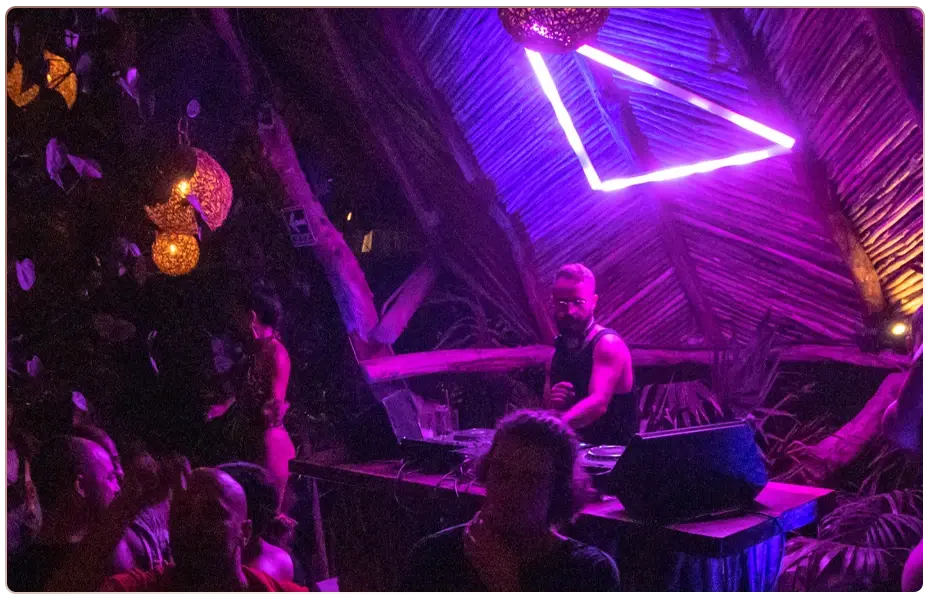 DJ playing at a wedding party in Tulum under neon lights