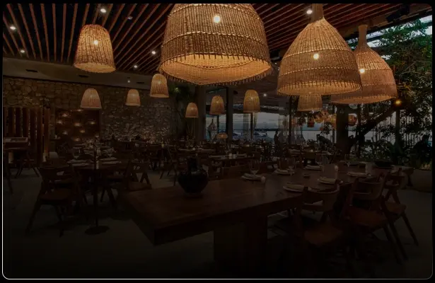 Restaurant in Cancún with wicker lamps and long tables
