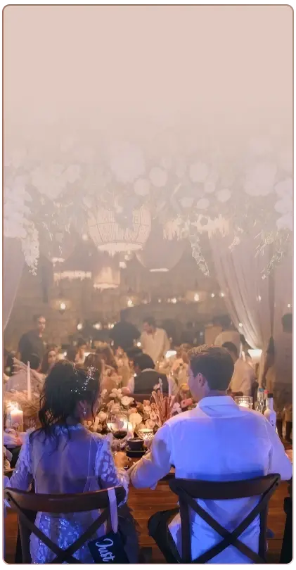 Couple seated at a nighttime wedding banquet in Tulum