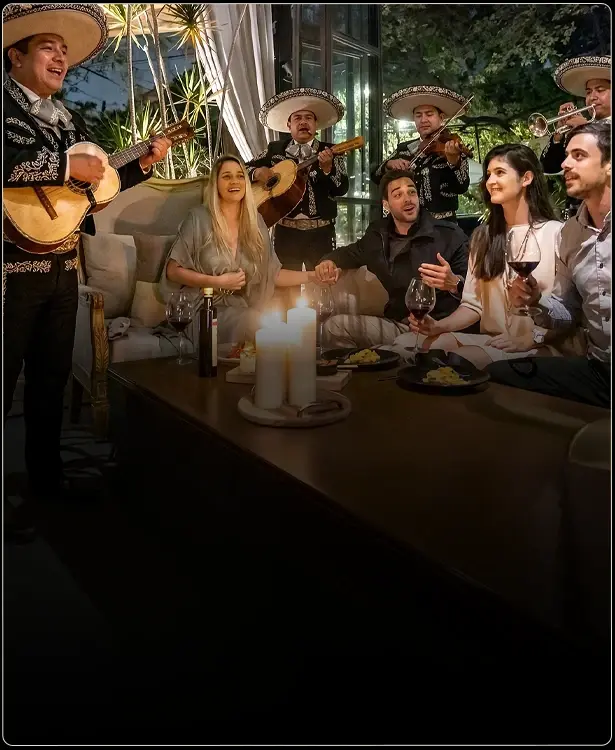 A group of people celebrating with mariachis at Parole Polanco