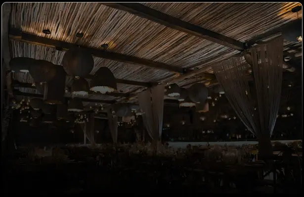 Nighttime terrace with a wooden roof at Grupos Tulum