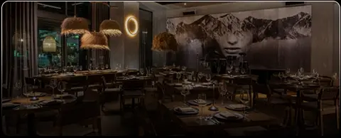 Rosa Negra Miami restaurant interior with dim lighting and an artistic mural